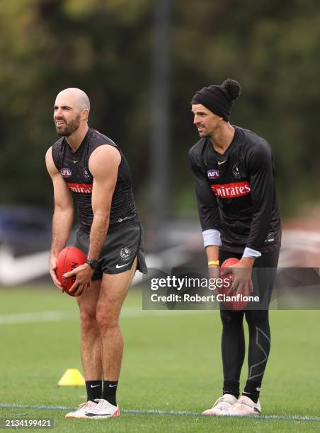 Steele Sidebottom and Scott Pendlebury of the Magpies look on during a Collingwood Magpies AFL training session at Olympic Park Oval on April 03,...