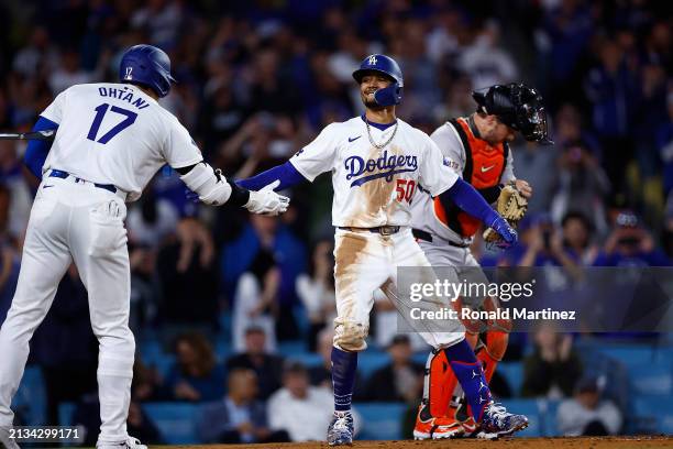 Mookie Betts of the Los Angeles Dodgers celebrates a home run with Shohei Ohtani against the San Francisco Giants in the third inning at Dodger...
