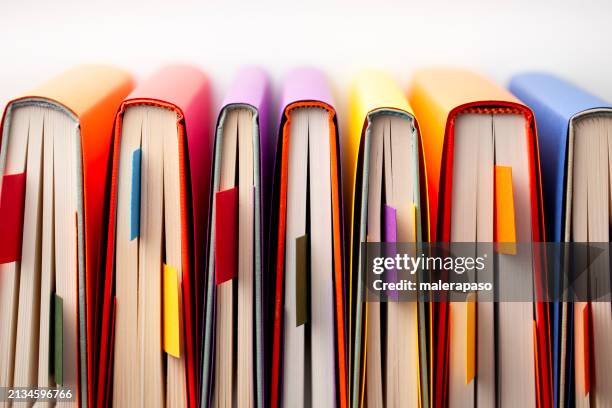 colored books seen from above with bookmark - children's literature stock pictures, royalty-free photos & images