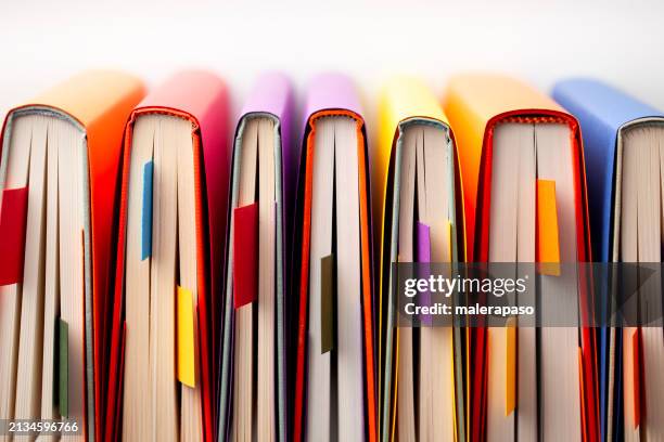 colored books seen from above with bookmark - bookshelf stock pictures, royalty-free photos & images