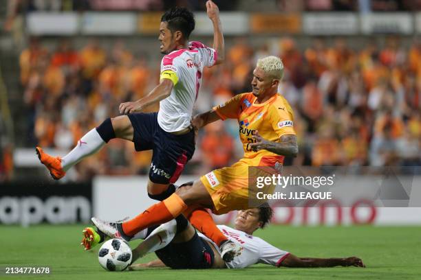 Crislan of Shimizu S-Pulse competes for the ball against Hotaru Yamaguchi and Tatsuya Yamashita of Cerezo Osaka during the J.League J1 match between...