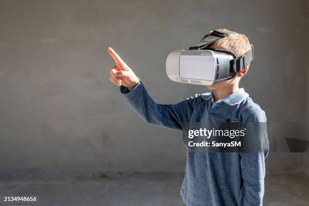 happy young boy using virtual reality glasses - smart glasses eyewear stock pictures, royalty-free photos & images