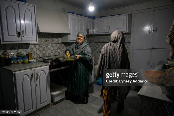 And former Parliamentarian from 2005 to 2010, Dr Roshanak Wardak, cooks dinner at home on October 23, 2023 in Wardak, in Wardak Province,...