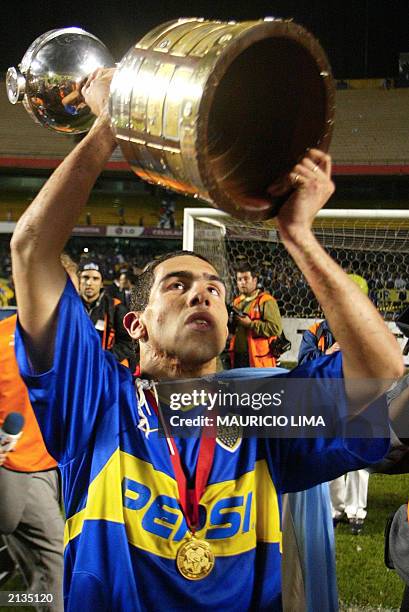 Carlos Tevez, of Boca Juniors of Argentina holds up the trophy after winning the Libertadores Cup against the Santos of Brazil, 02 July, 2003 at the...