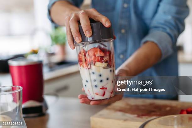 close up of hands holding smoothie blender bottle with fruits and milk for healthy fruit smoothie. - smoothie bildbanksfoton och bilder
