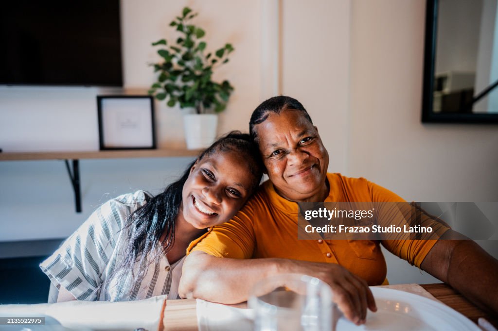 Portrait of grandmother and granddaughter at home