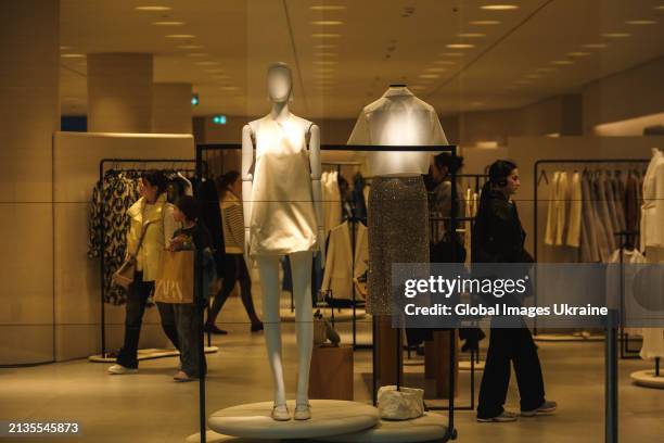 Shoppers choose clothing in a Zara store, that belongs to the Spanish Inditex group, during brand store reopening in the Respublika Park shopping...