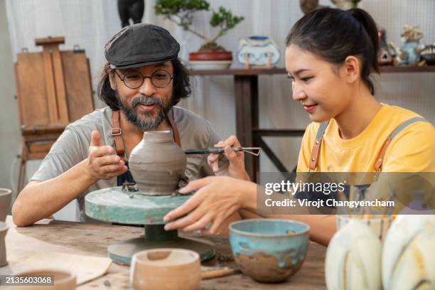 a ceramic artist is teaching students at art studio - east asian works of art specialist stock pictures, royalty-free photos & images