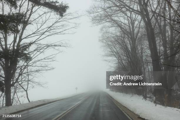 Fog, rising from recently fallen snow on a spring day in a process called inversion, envelops the roads and farm fields of rural Maine, March 28...