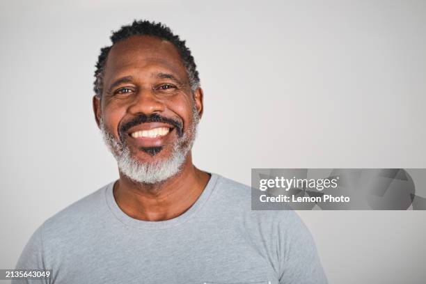 waist up shot of a handsome hispanic latino carefree black male looking at the camera with big smile - male face smile stockfoto's en -beelden
