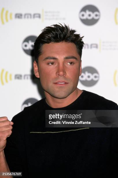 Mexican-American boxer Oscar De La Hoya, wearing a black sweater with a white horizontal stripe on the chest, attends the 2000 Radio Music Awards, at...