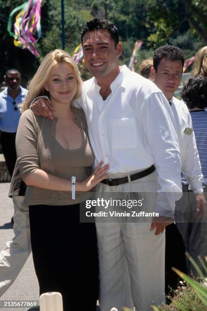 American beauty queen and actress Shanna Moakler, wearing a scoop neck khaki top with a matching cardigan and a black skirt, and Mexican-American...