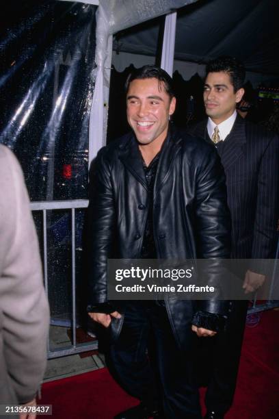 Mexican-American boxer Oscar De La Hoya, wearing a black leather jacket, attends the Grand Opening of the 'Conga Room', a nightclub on Wilshire...