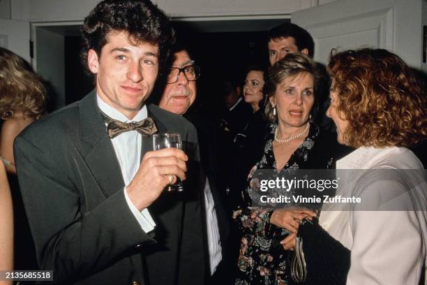 American actor Patrick Dempsey, wearing a tuxedo with a brown bow tie and matching cummerbund, and his wife, American actress Rochelle 'Rocky'...