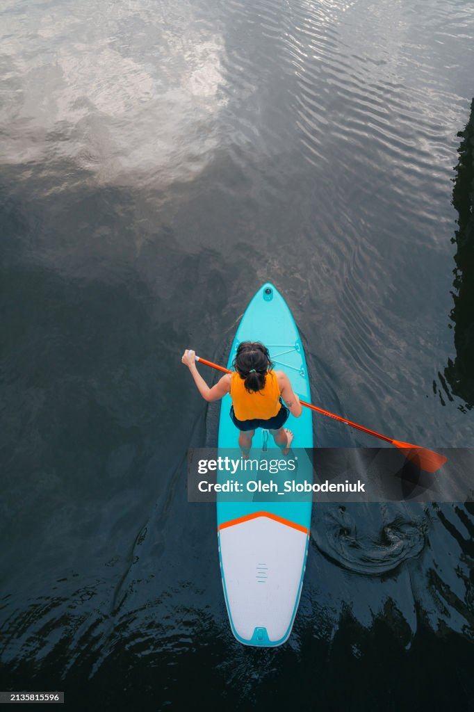High angle view of woman SUP boarding