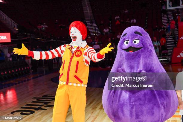 Perfromers in "Ronald McDonald" and "Grimace" costumes attend the 47th annual McDonald's All American Games at Toyota Center on April 02, 2024 in...