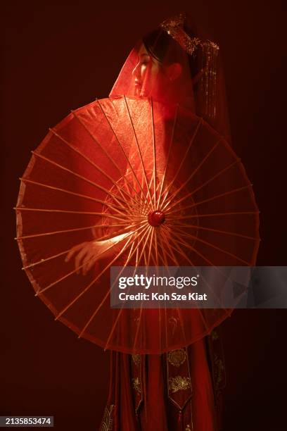 stunning backlit portrait of an asian chinese woman in traditional bridal tea dress and umbrella - rim light portrait stock pictures, royalty-free photos & images