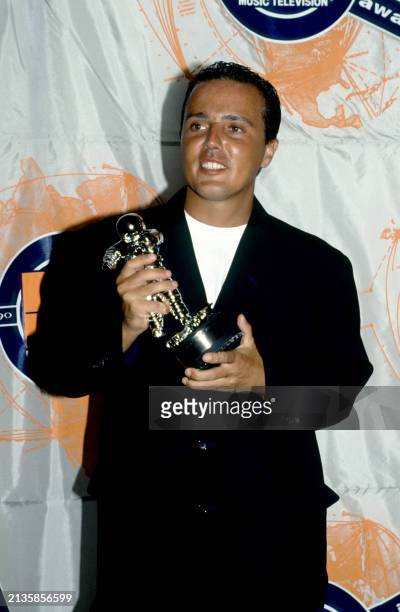 English singer Curt Smith, of the English pop rock band Tears For Fears, poses with an MTV Moonman award during the 1990 MTV Video Music Awards at...