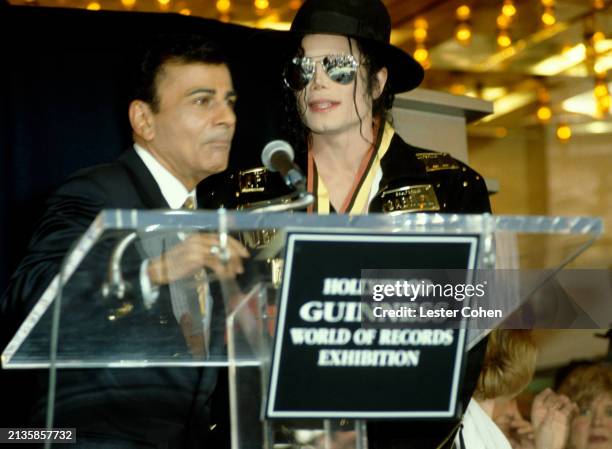 American disc jockey Casey Kasem and American singer Michael Jackson stand at the podium during the Guinness Book of Records Lifetime Achievement...