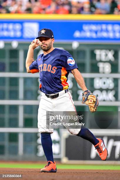 Jose Altuve of the Houston Astros fields a ball against the Toronto Blue Jays at Minute Maid Park on April 02, 2024 in Houston, Texas.