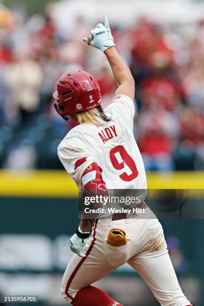 Wehiwa Aloy of the Arkansas Razorbacks signals to the fans after hitting a home run during the game against the LSU Tigers at Baum-Walker Stadium at...
