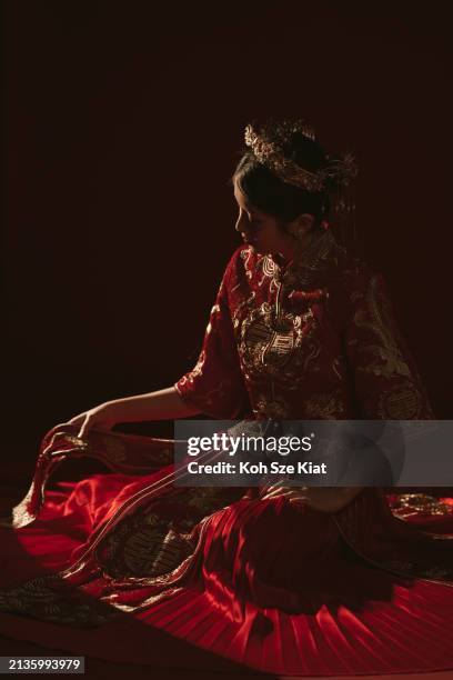 backlit portrait of an asian chinese woman in traditional bridal tea dress and headwear kneeling on the floor - rim light portrait stock pictures, royalty-free photos & images