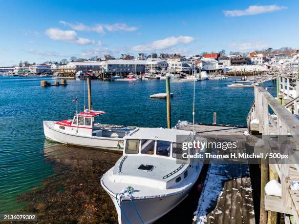 high angle view of boats moored at harbor against sky,united states,usa - southport-maine stock pictures, royalty-free photos & images