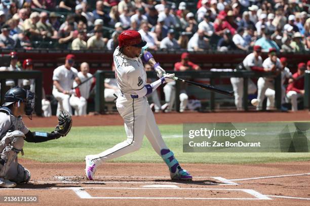 Ketel Marte of the Arizona Diamondbacks hits a double for his 1000th career hit in the first inning during a game against the New York Yankees at...