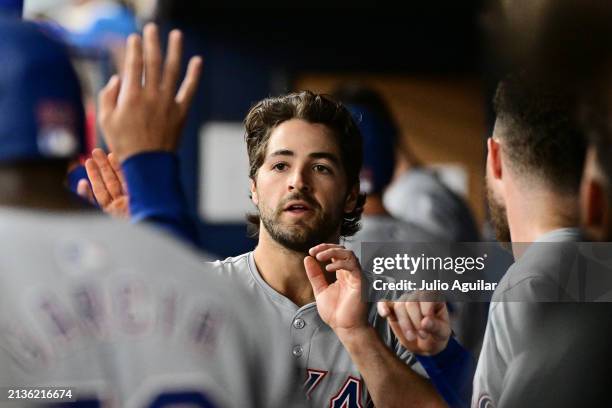 Josh Smith of the Texas Rangers celebrates with teammates in the dugout after scoring in the ninth inning against the Tampa Bay Rays at Tropicana...