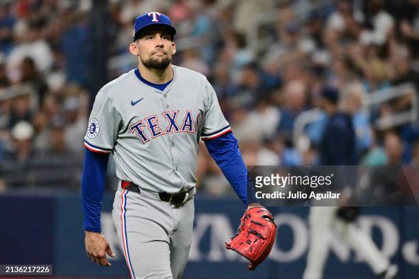 Nathan Eovaldi of the Texas Rangers walks off the field following the second inning against the Tampa Bay Rays at Tropicana Field on April 03, 2024...