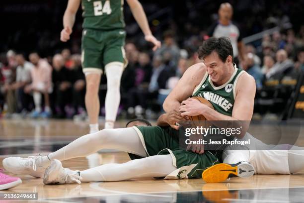 Danilo Gallinari of the Milwaukee Bucks grabs the ball from Jared Butler of the Washington Wizards during the first half at Capital One Arena on...