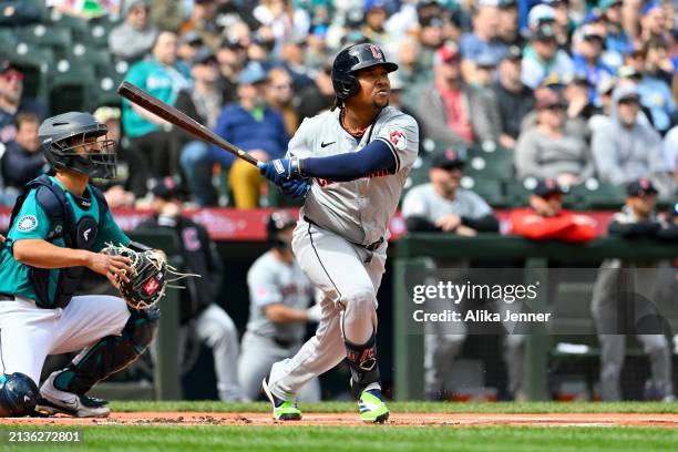 Jose Ramirez of the Cleveland Guardians hits a hits an RBI double during the first inning against the Seattle Mariners at T-Mobile Park on April 03,...