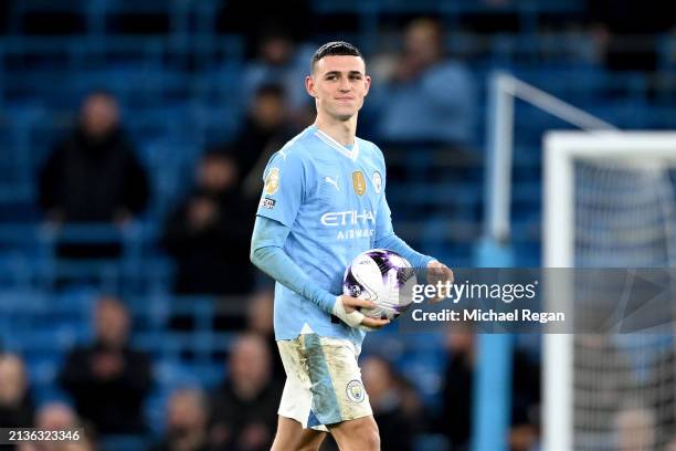 Phil Foden of Manchester City celebrates victory on pitch with the match ball after scoring a hat-trick during the Premier League match between...