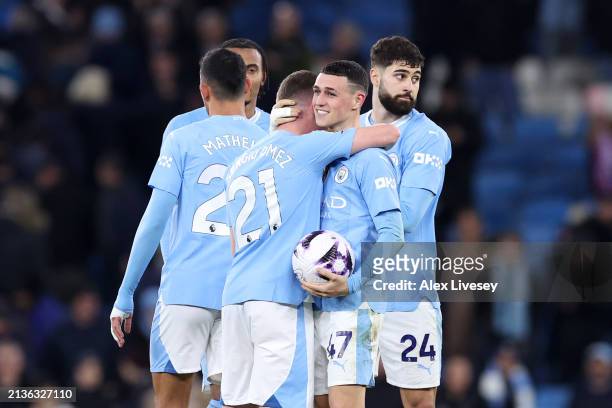 Phil Foden of Manchester City celebrates victory on pitch with the match ball after scoring a hat-trick during the Premier League match between...