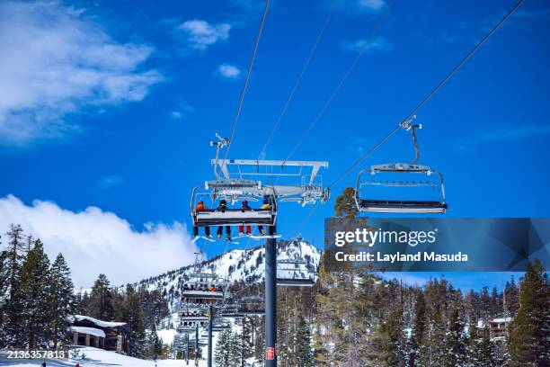 ski lift with people and snowy mountain - wintersportort stock-fotos und bilder