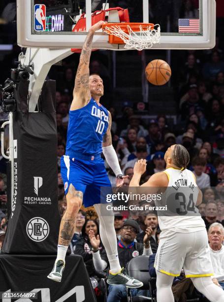 Clippers center Daniel Theis gets an open slam dunk over Utah Jazz Kenneth Loft Jr. In the fourth quarter at Crypto.com Arena on April 5, 2024 in Los...