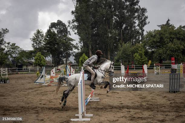 Equestrian jumps his horse during a show jumping competition in Addis Ababa on April 6, 2024.