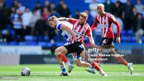 Lincoln City's Ted Bishop vies for possession with Reading's Sam Smith during the Sky Bet League One match between Reading and Lincoln City at Select...
