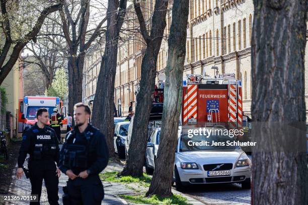 Rescue forces and riot police officers stand in a street where a man was suspected of building a bomb in his apartment on April 6, 2024 in Halle,...