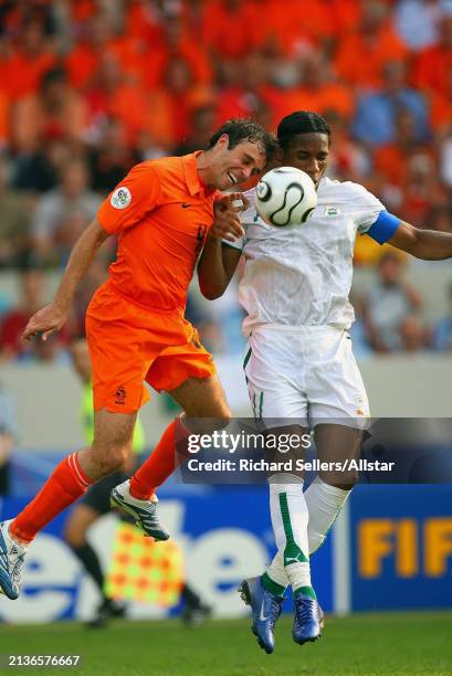 June 16: Joris Mathijsen of Holland and Didier Drogba of Ivory Coast challenge during the FIFA World Cup Finals 2006 Group C match between Holland...