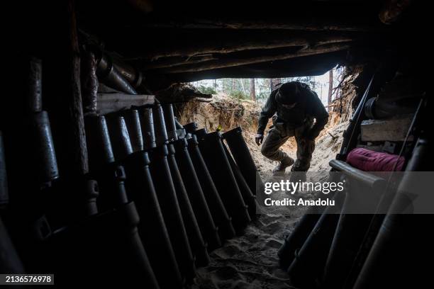 Ukrainian serviceman of 63rd brigade enters a trench with military ammunition at an artillery position of an American M777 howitzer in the direction...