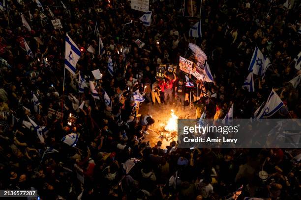 Protesters light a fire during a demonstration calling for a hostages deal and against the Israeli government on April 6, 2024 in Tel Aviv, Israel....