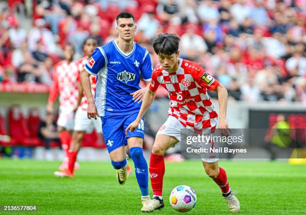 Jae Sung Lee of 1.FSV Mainz 05 in action with the ball during the Bundesliga match between 1. FSV Mainz 05 and SV Darmstadt 98 at MEWA Arena on April...