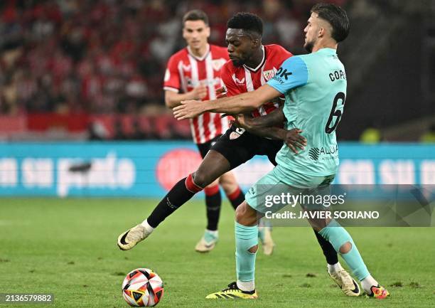 Athletic Bilbao's Spanish forward Inaki Williams vies with Athletic Bilbao's Spanish midfielder Mikel Vesga during the Spanish Copa del Rey final...