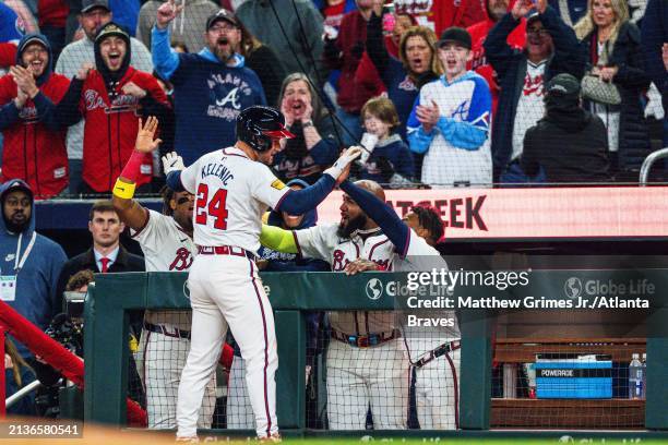 Jarred Kelenic celebrates with Ronald Acuña Jr. #13, Raisel Iglesias, Marcell Ozuna, and Ozzie Albies of the Atlanta Braves after tying the game in...