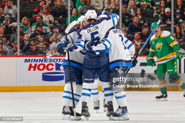 Brenden Dillon of the Winnipeg Jets celebrates his goal with his teammates against the Minnesota Wild during the game at the Xcel Energy Center on...