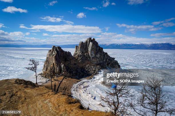 View of the Shamanka Rock located on Lake Baikal in Siberia. The Shamanka Rock is known as a natural temple for practitioners of shamanism and...