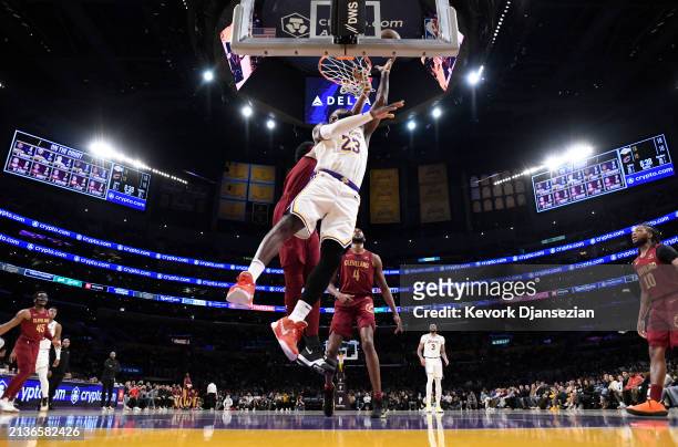 LeBron James of the Los Angeles Lakers scores a basket against Jarrett Allen of the Cleveland Cavaliers during the first half at Crypto.com Arena on...
