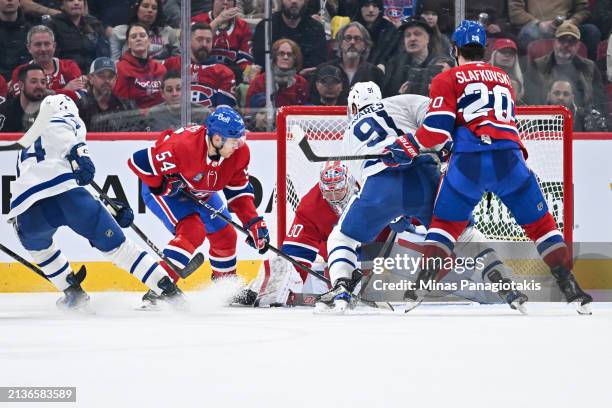 Goaltender Cayden Primeau of the Montreal Canadiens covers the puck during the second period against the Toronto Maple Leafs at the Bell Centre on...