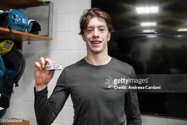 Collin Graf of the San Jose Sharks poses with a puck commemorating his first NHL game against the St. Louis Blues at SAP Center on April 6, 2024 in...